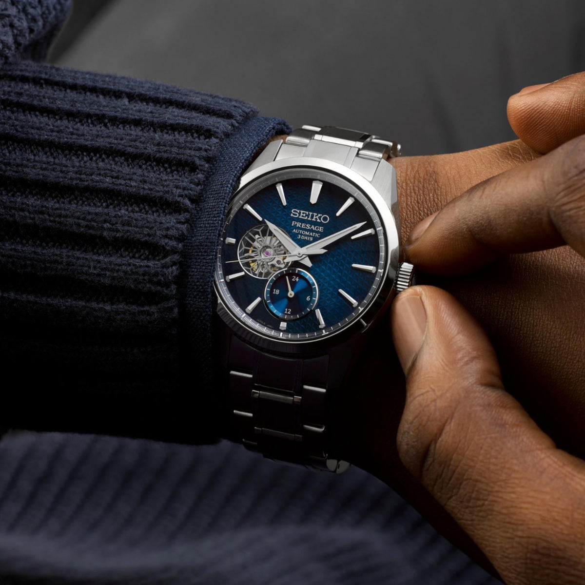 Seiko Presage open-heart watch worn with blue dial and stainless steel bracelet
