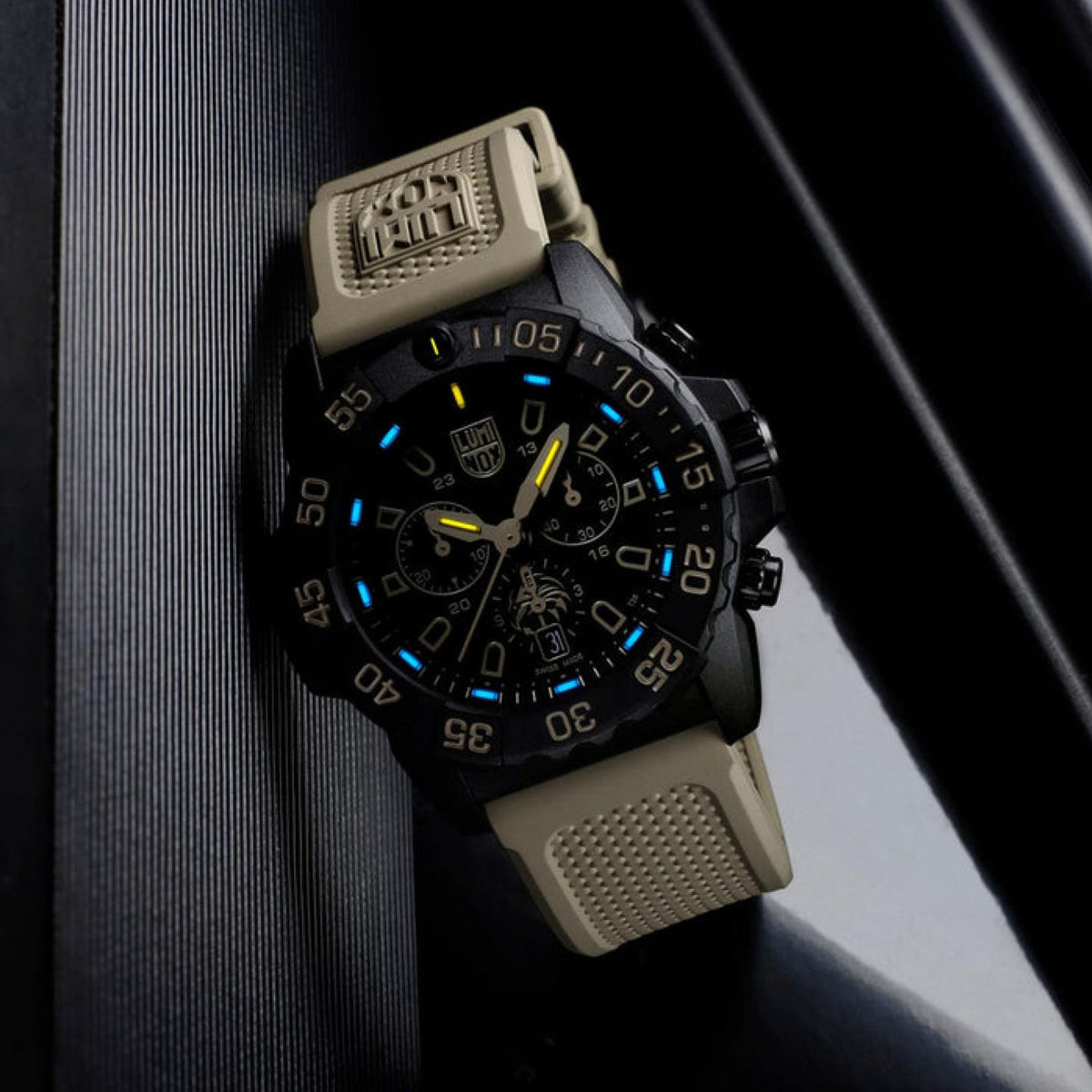 Men's black rubber chronograph watch with blue lume accents on the dial and bezel