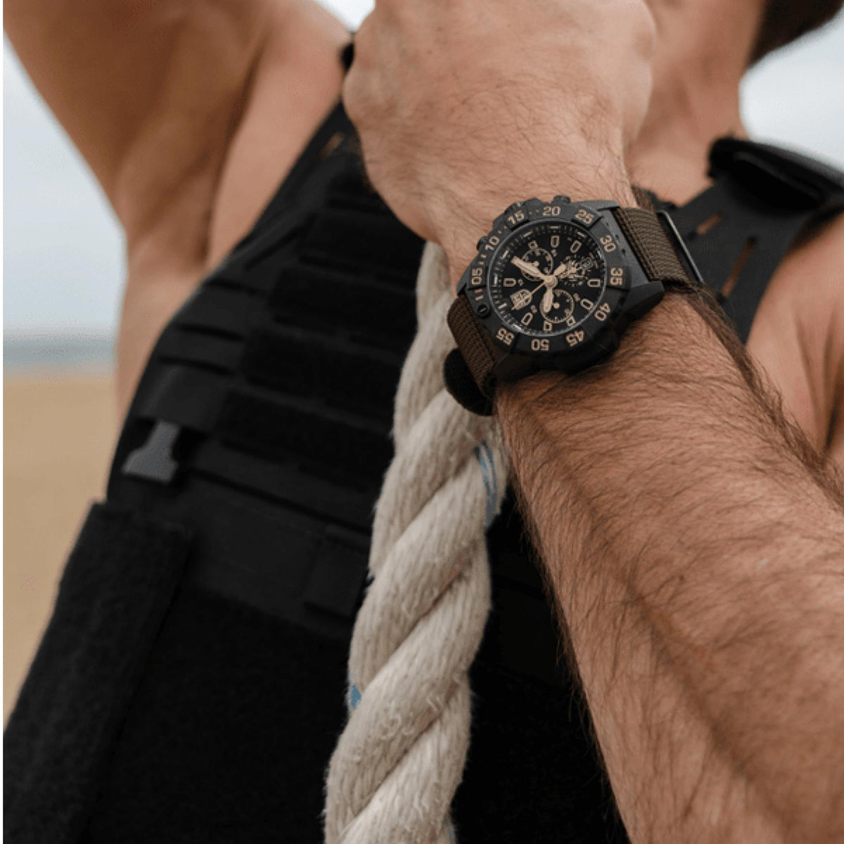 Men's black dial chronograph watch with black rubber strap and visible crown