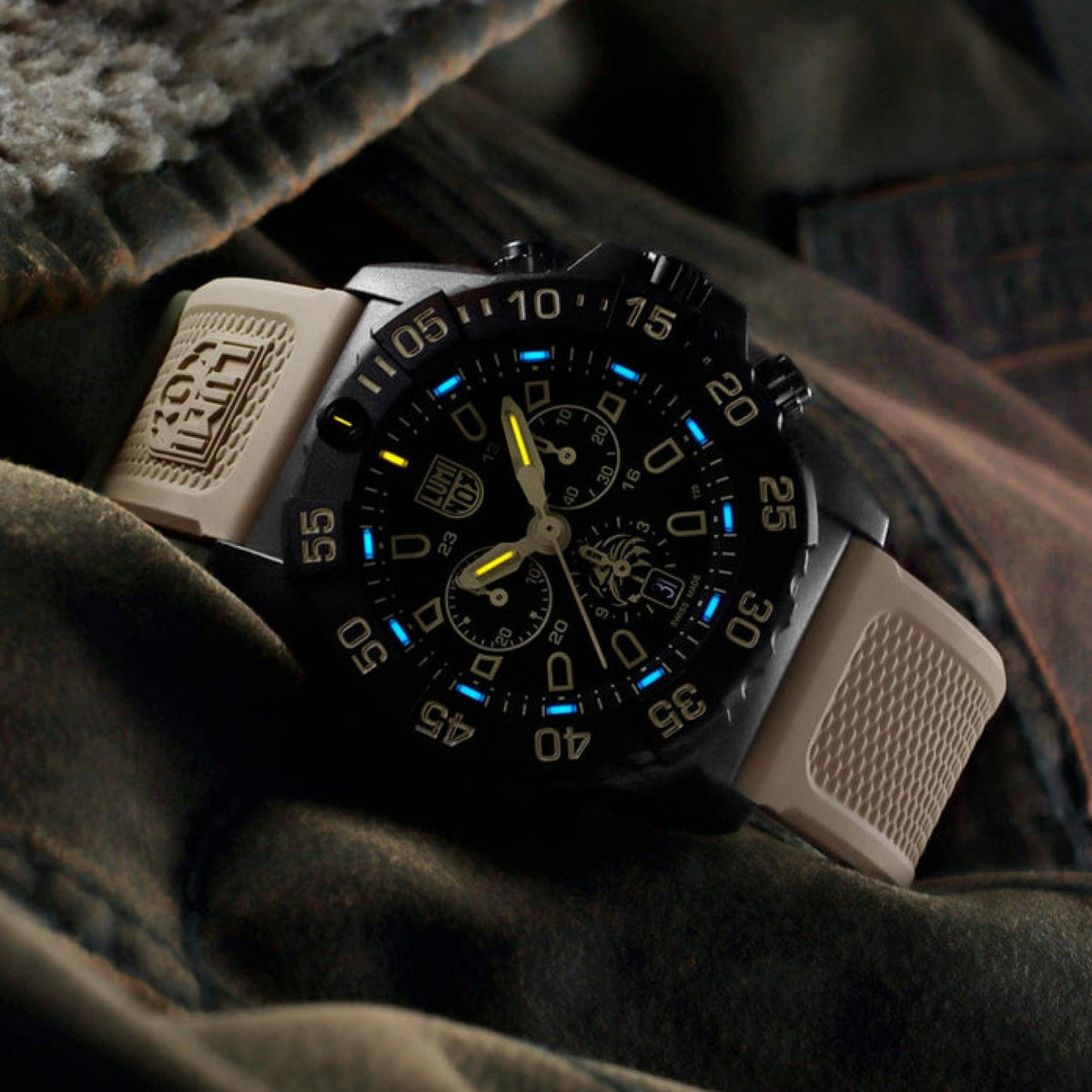Black dial chronograph watch with blue luminous markers and gold tone hands