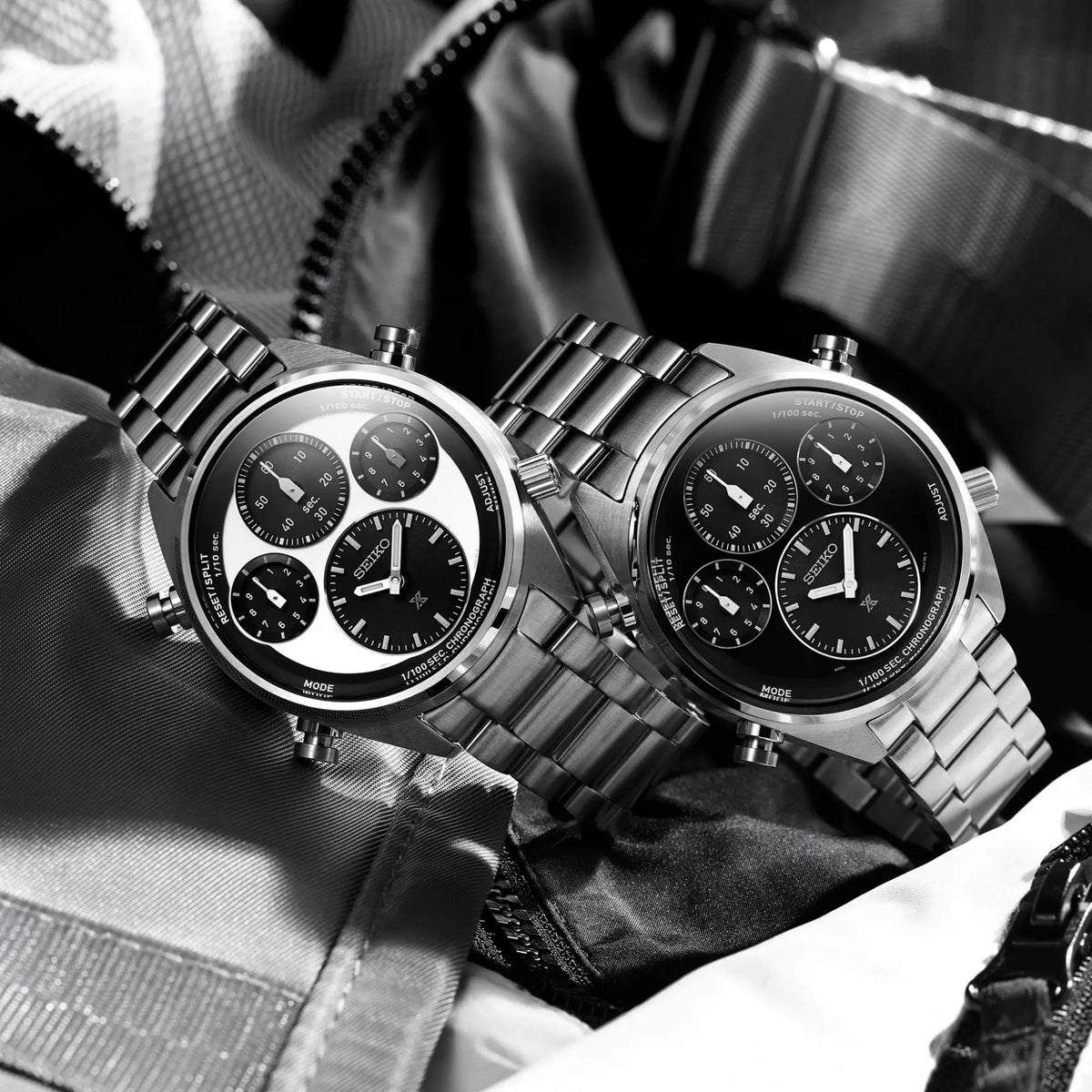Pair of men's solar chronograph watches with steel bracelets and black/white dials