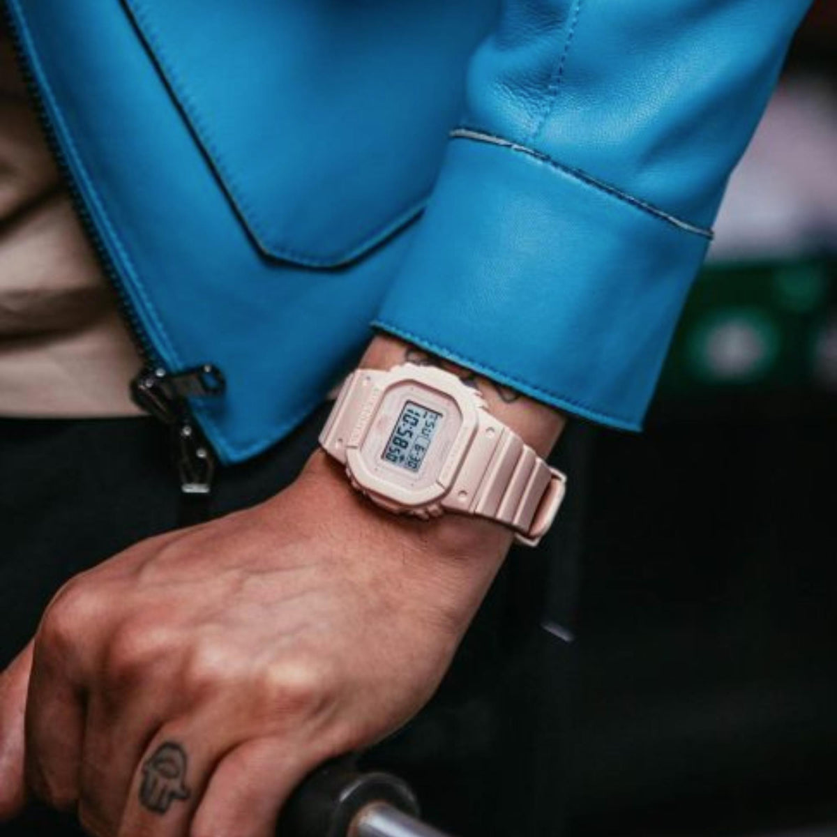 Pink resin digital G-Shock watch worn on wrist with chunky protective bezel