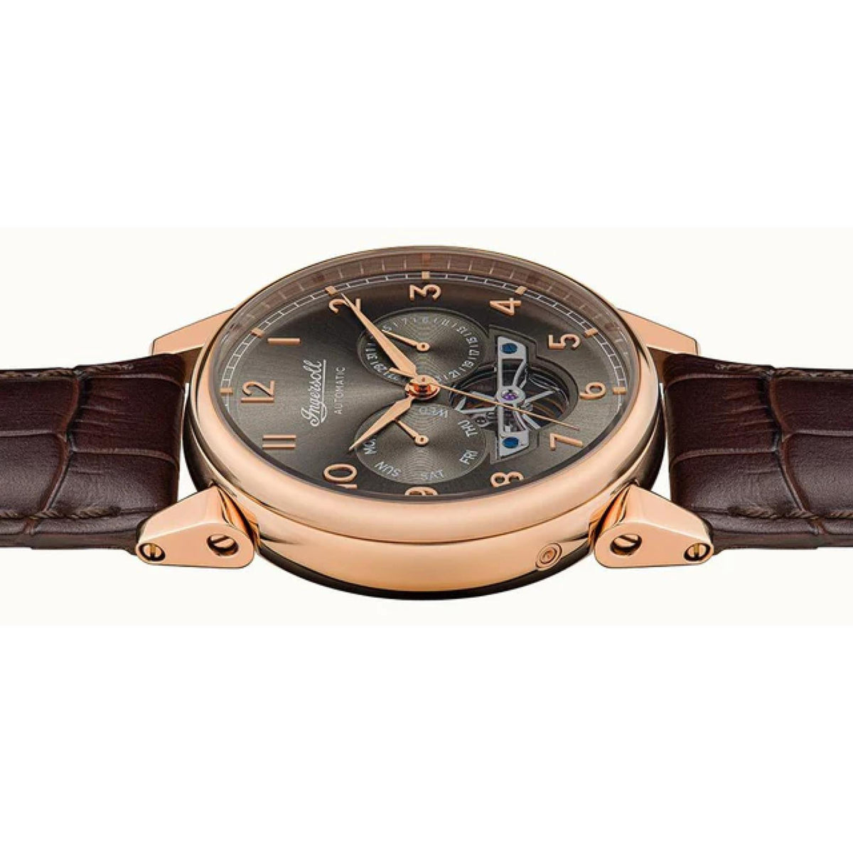 Men's automatic watch angled front view with rose-gold case, dark dial, and brown leather strap