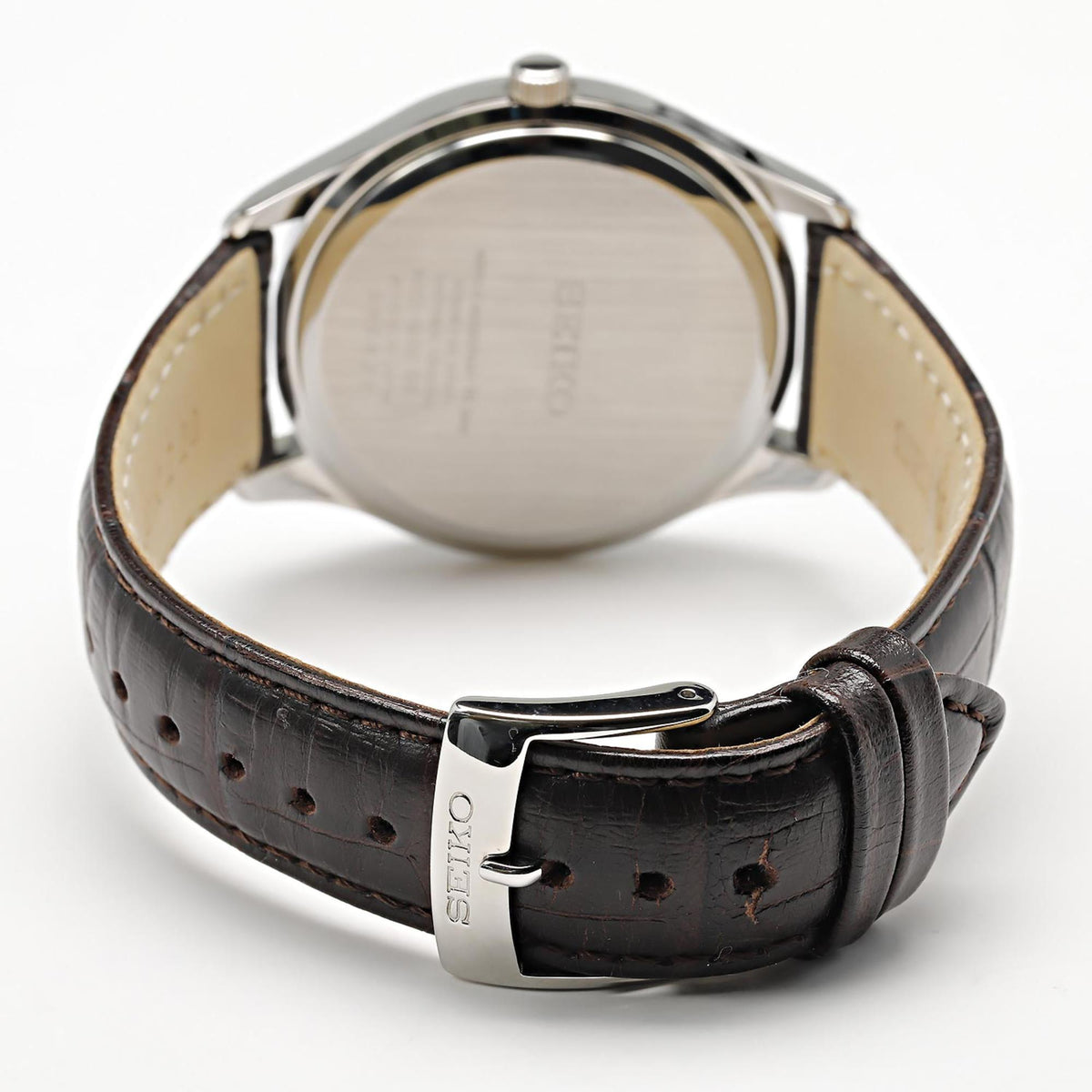 Seiko Essentials SUR421P1 stainless steel case back and silver buckle close up