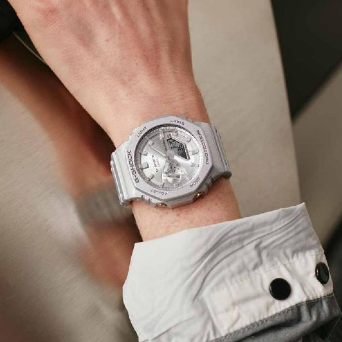 G-Shock silver watch on wrist with gray dial and wide resin case