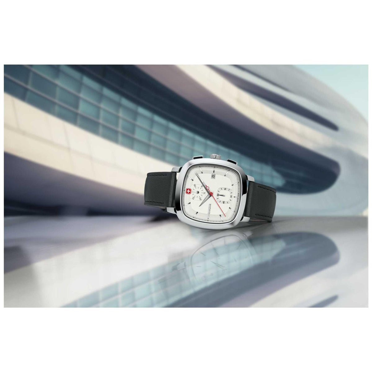 Chronograph watch on black strap with silver case, white dial and red second hand.