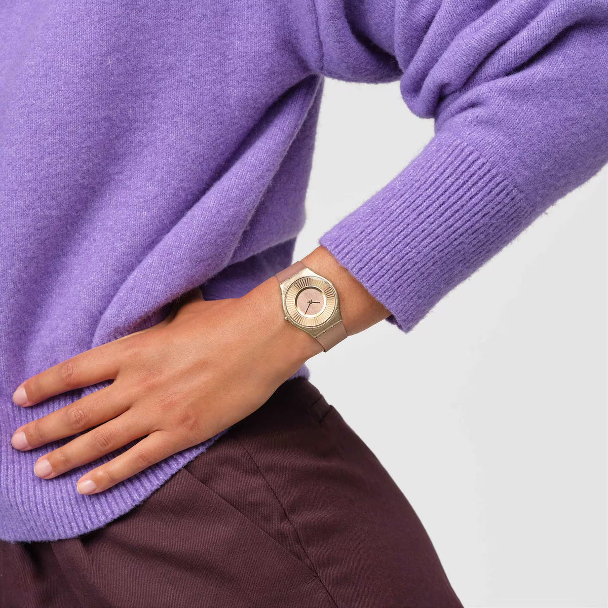 Tawny silicone strap quartz watch with gold-tone round dial on wrist