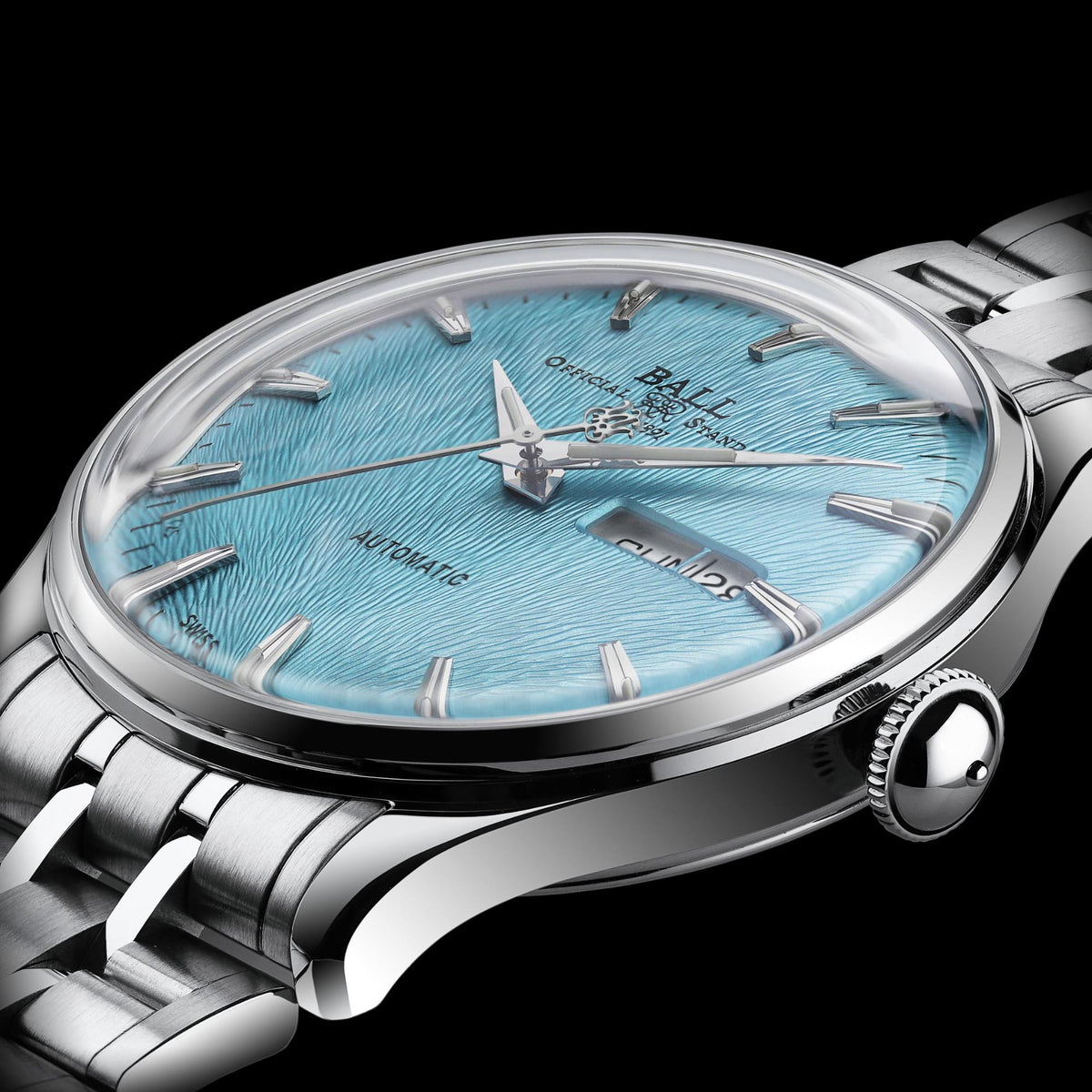 Macro view of men's automatic wristwatch with ice blue textured dial and stainless bezel