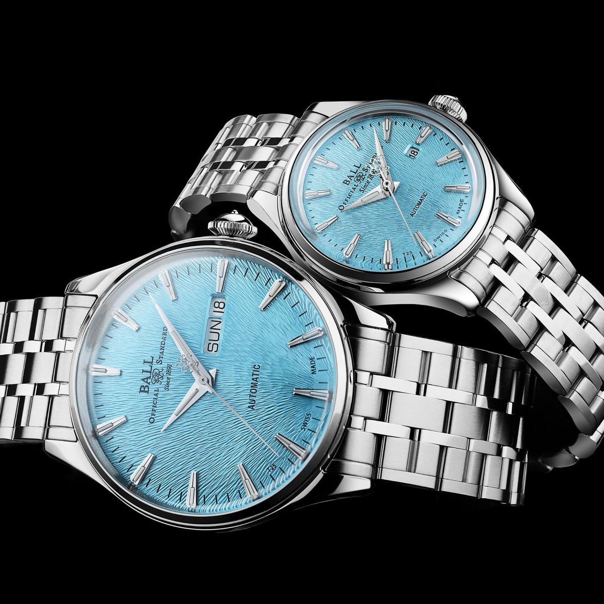 Two men's automatic wristwatches with ice blue dials and stainless bracelets, angled view