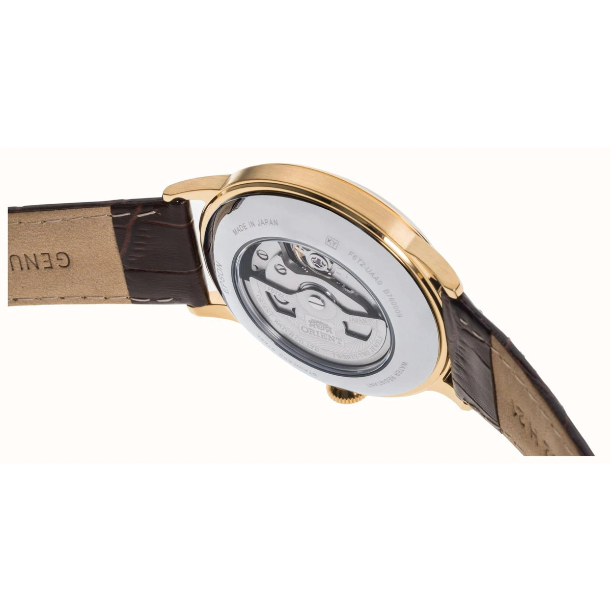 Gold-tone watch caseback with mechanical movement, seen from side on brown leather strap
