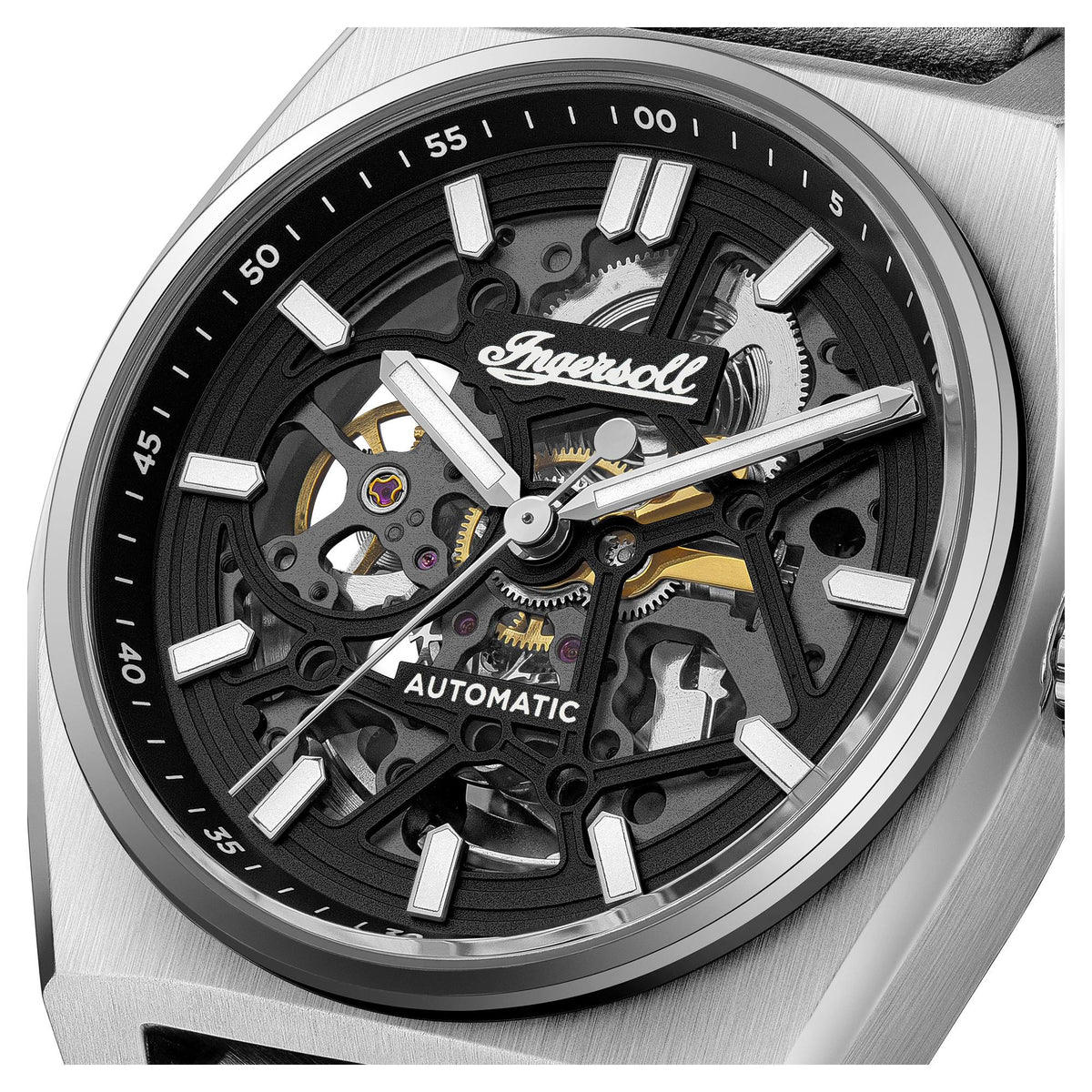 Automatic skeleton dial close-up with black gears, white markers, and silver hands