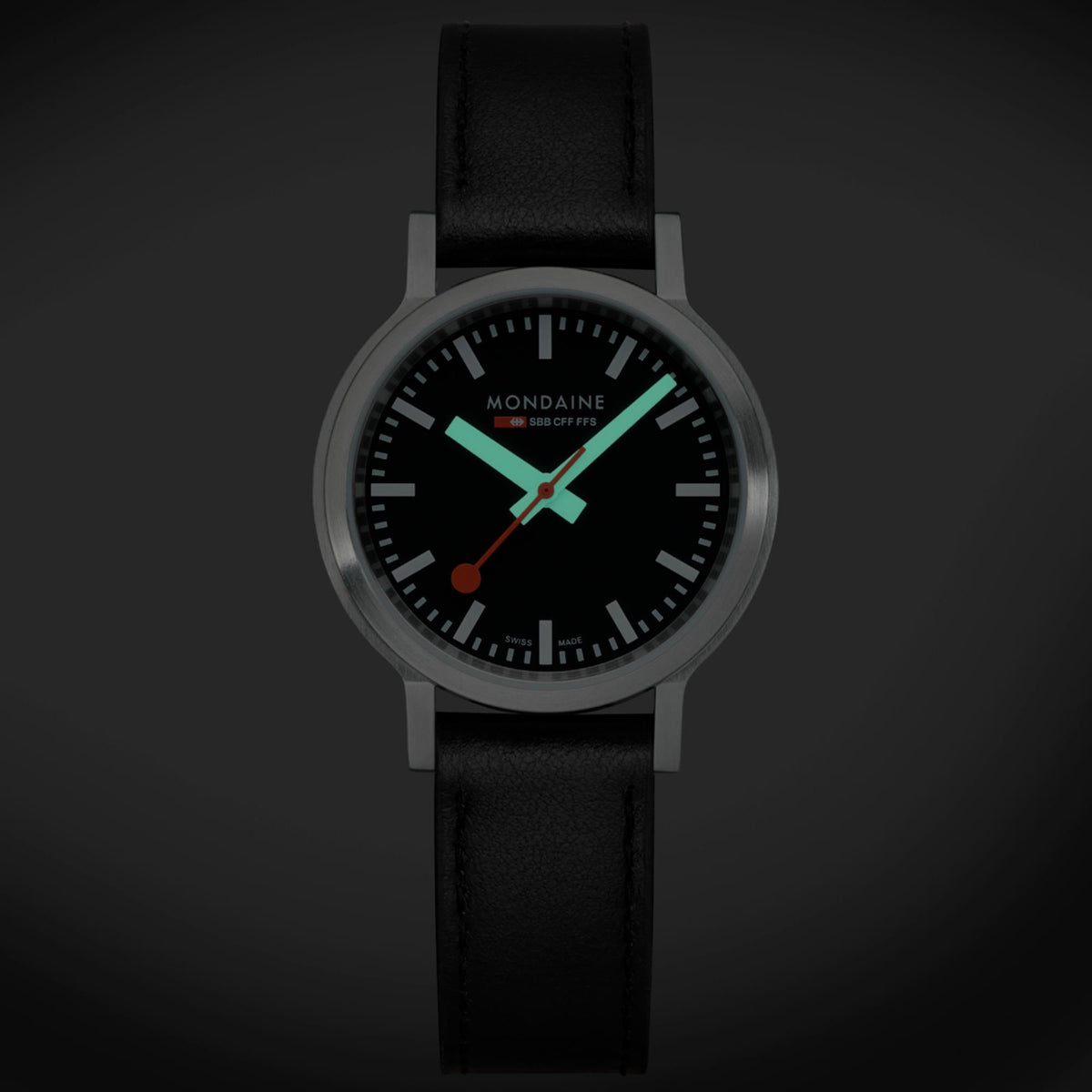 Black dial quartz watch with black leather strap, silver-tone case and teal accents