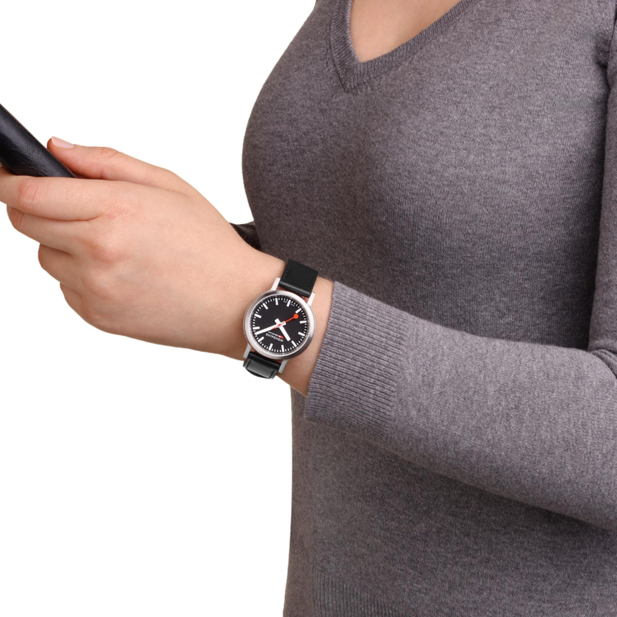 Black dial quartz watch with black leather strap worn on wrist, silver-tone case