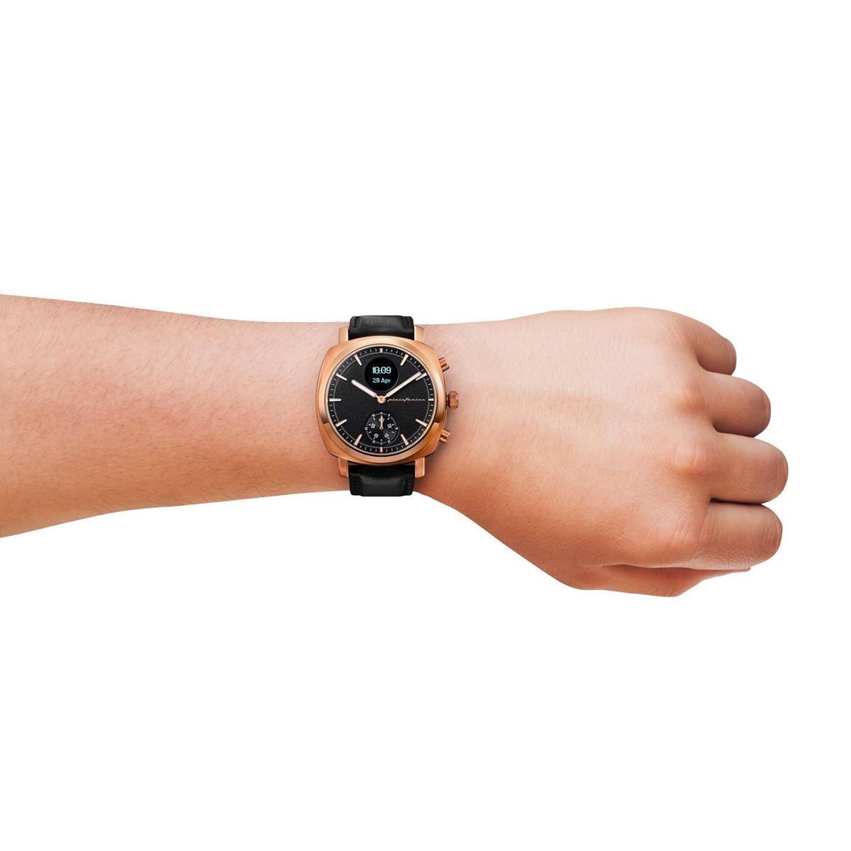 Rose gold-tone watch on wrist with black leather strap and black dial with markers.