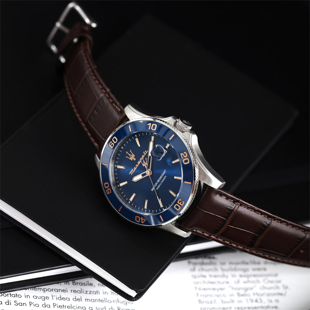 Men's quartz watch with blue dial, silver bezel, and brown leather strap detail