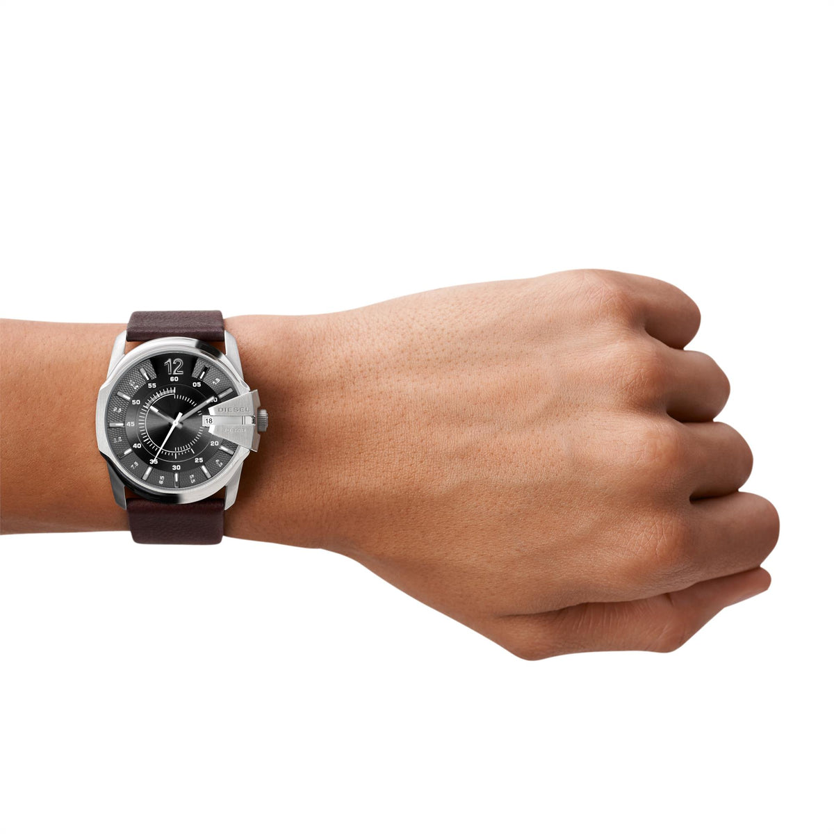 Men's quartz watch on wrist with brown leather strap and dark dial