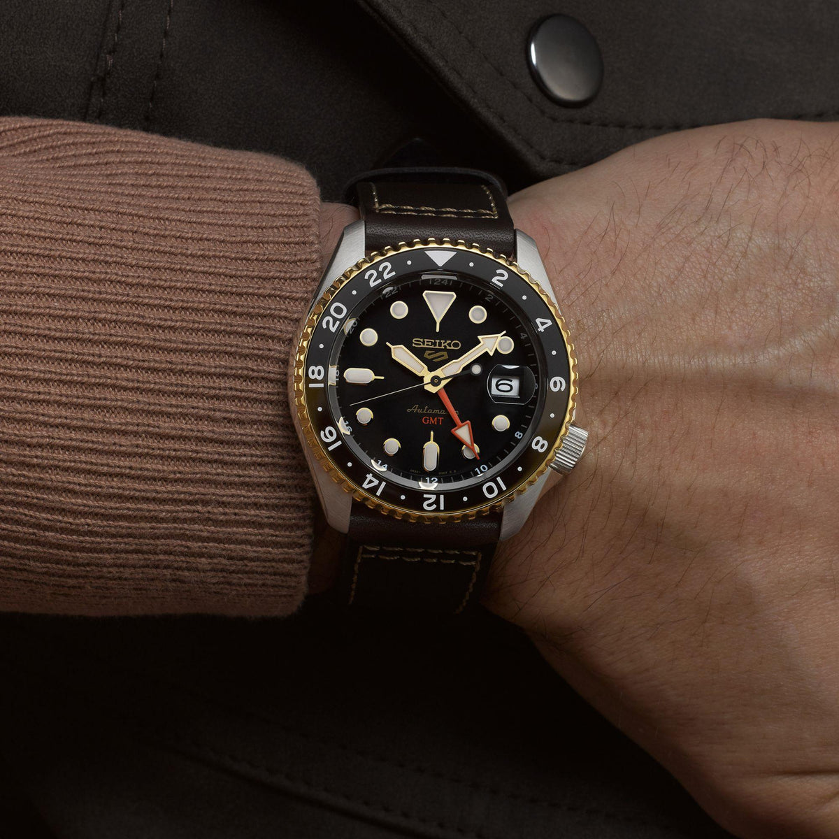 Seiko 5 Sports automatic GMT watch with black dial, gold bezel, brown leather strap