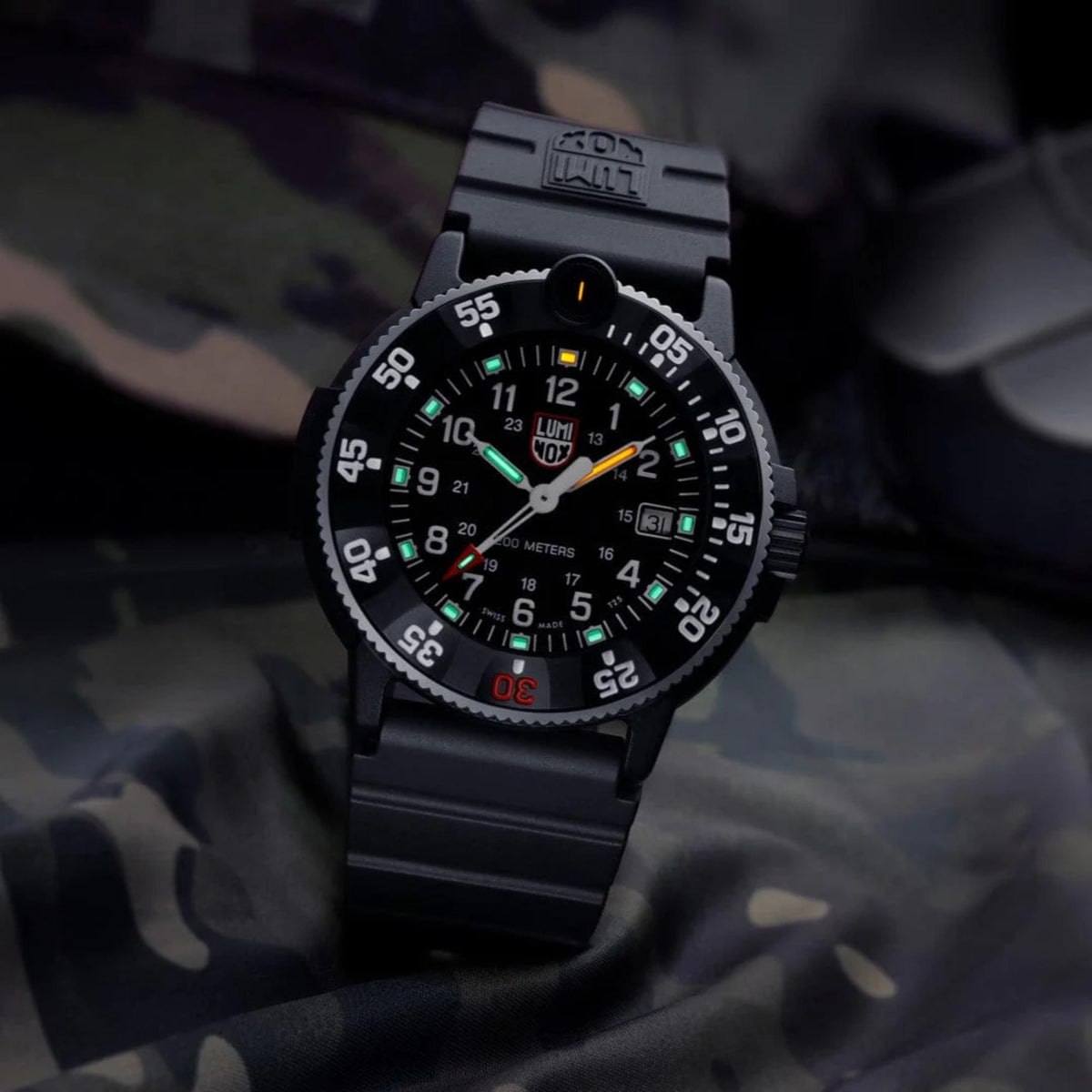 Men's black rubber dive watch with glowing green dial markers and black bezel