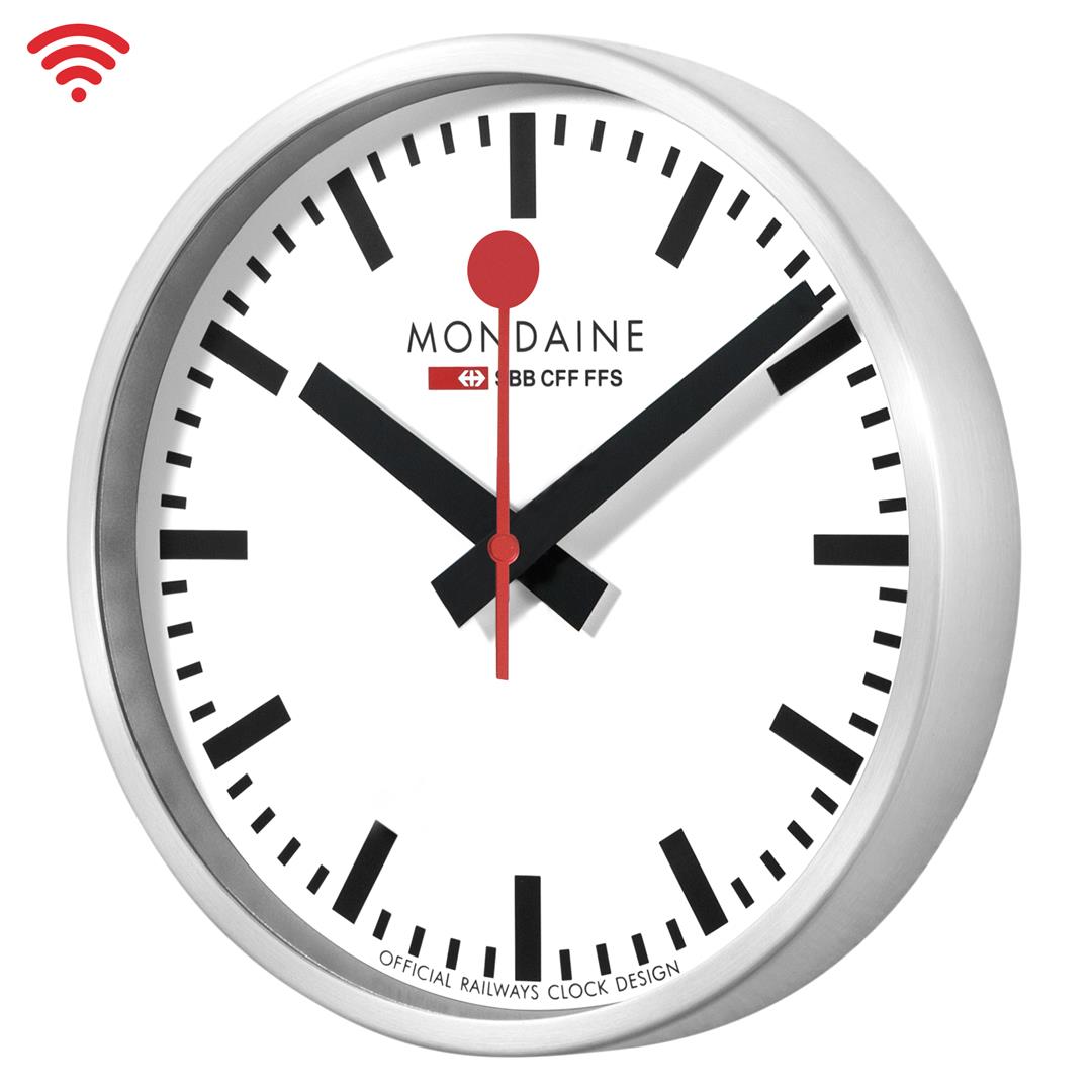 Mondaine Wi‑Fi wall clock close-up with white dial, red hands, and silver bezel