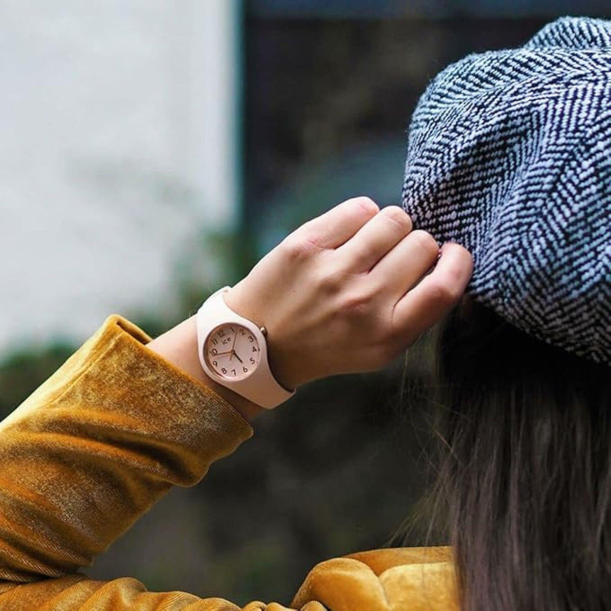 Pink dial silicone strap watch on wrist, rose-pink bezel and round case