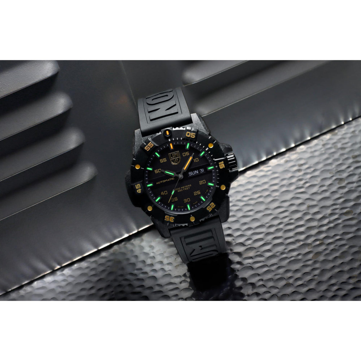 Men's automatic watch, close-up black dial with yellow markers, black rubber strap