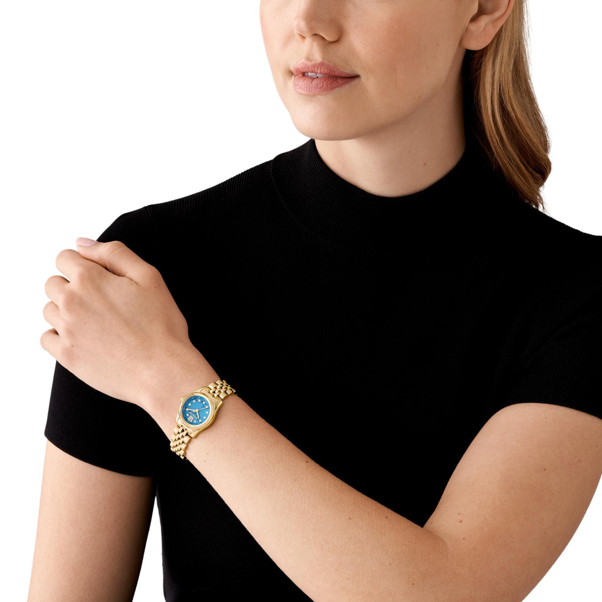 Gold-tone stainless steel blue-dial watch worn on wrist, Roman numeral markers visible