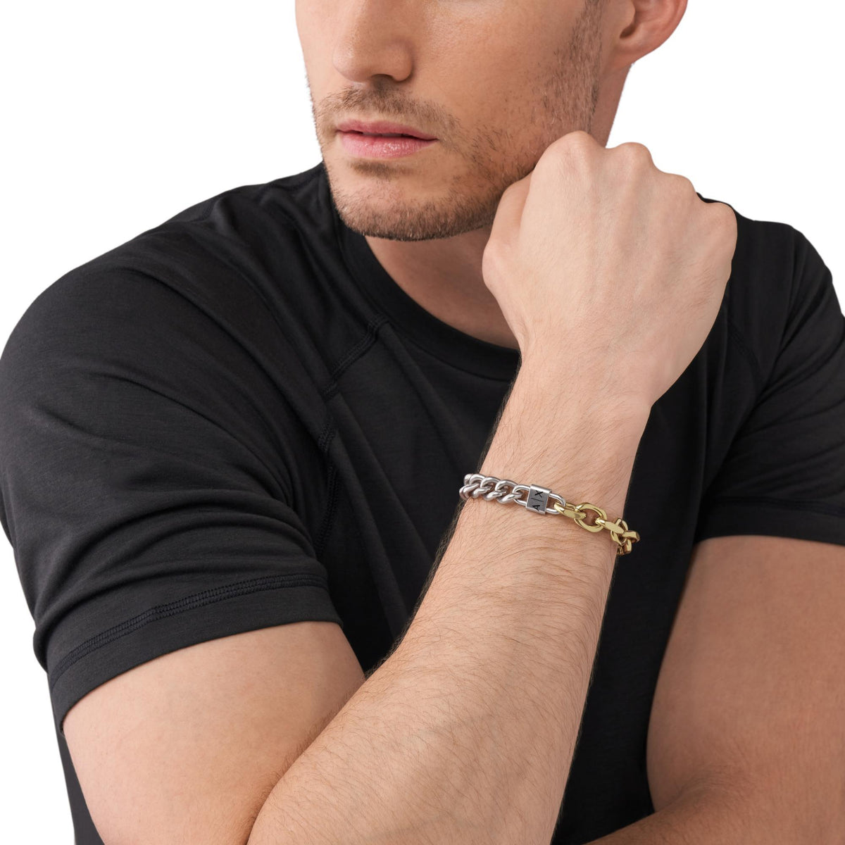 Armani Exchange two-tone stainless steel chain bracelet worn on wrist with AX logo clasp