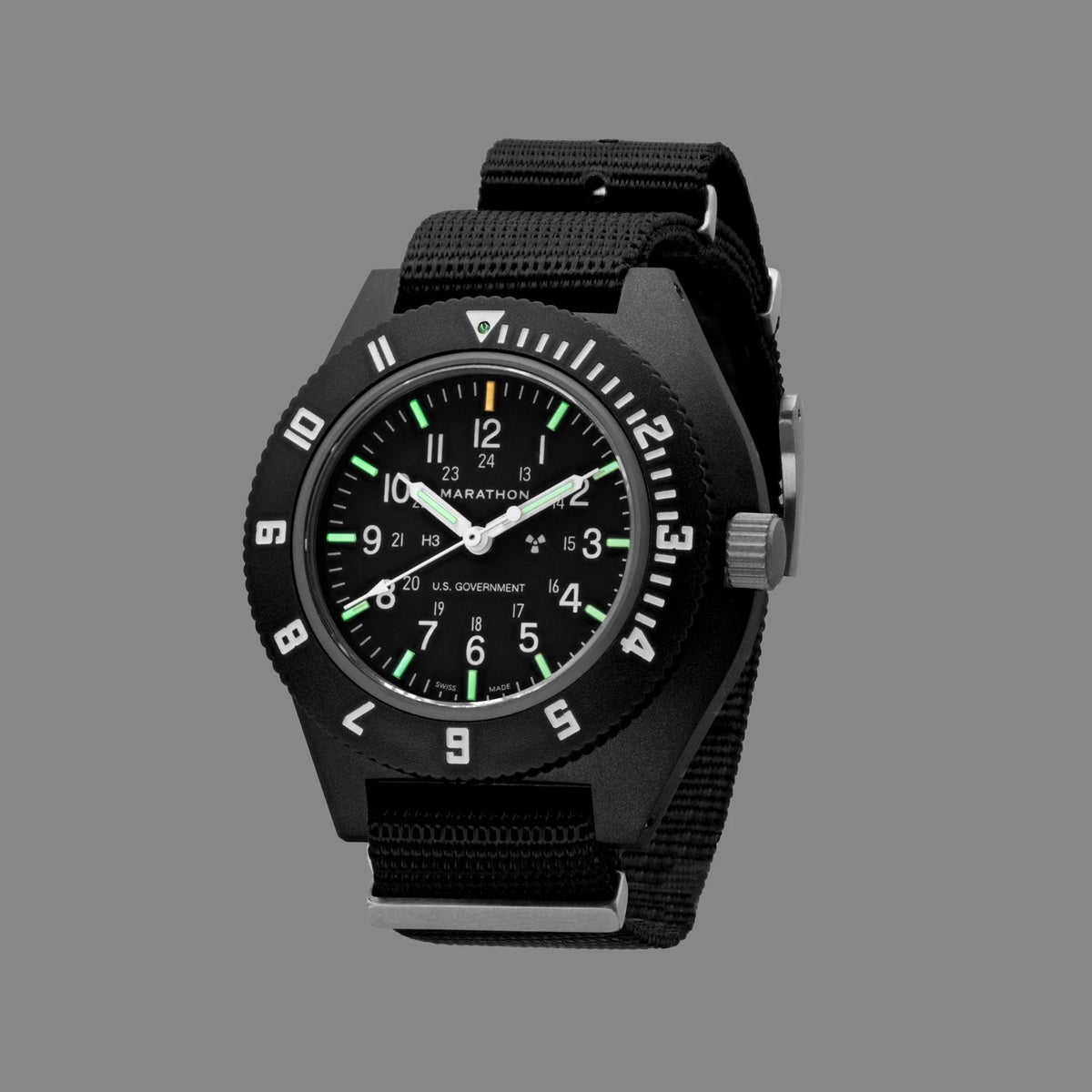 Black men’s quartz navigator wristwatch with black dial and green-tinted markers on fabric strap
