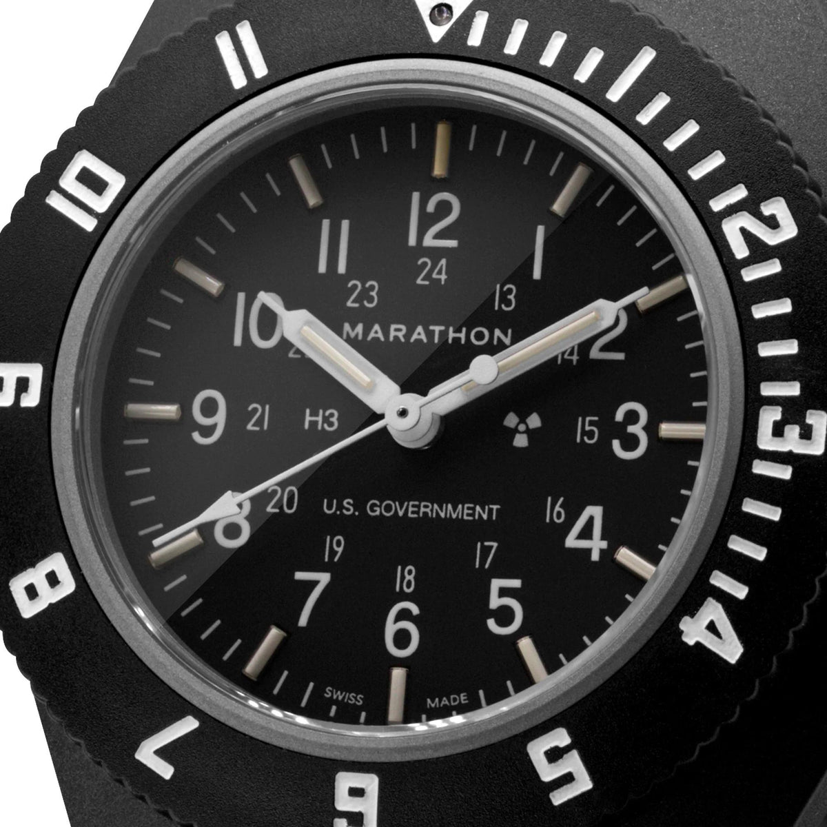 Close-up black dial navigator watch with luminous hands, bezel numerals, and fabric case