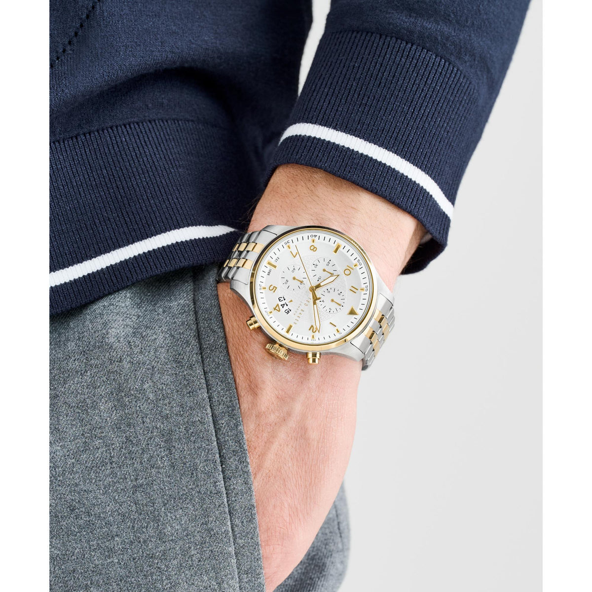 Two-tone men's watch on wrist, white dial with gold accents and silver bracelet links