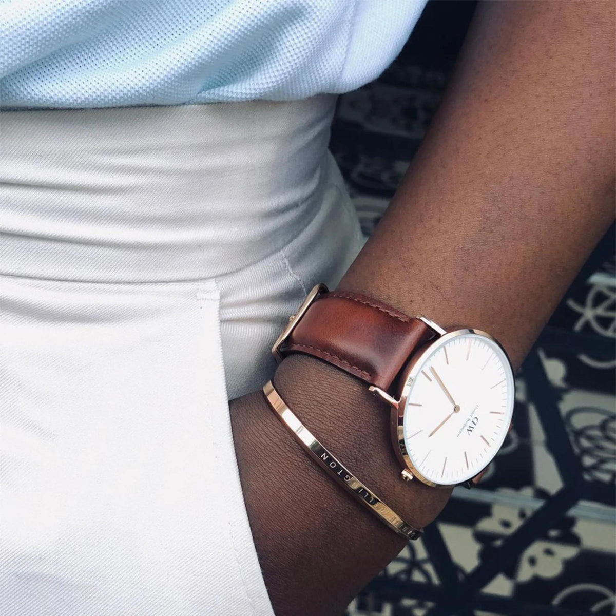 Leather quartz watch on wrist with brown strap and white dial, rose gold case