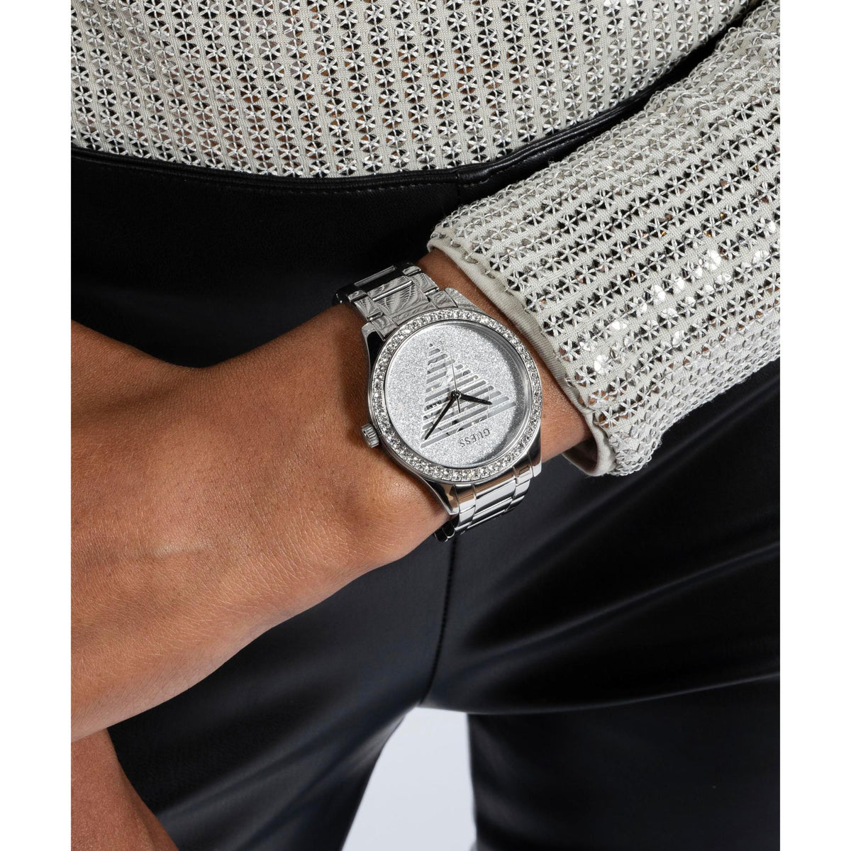 Ladies analog watch on wrist with silver dial and stainless steel link strap