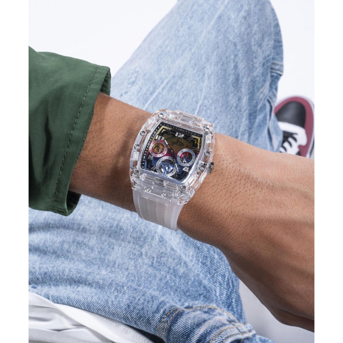 Transparent multi-dial watch worn on wrist with thick clear strap