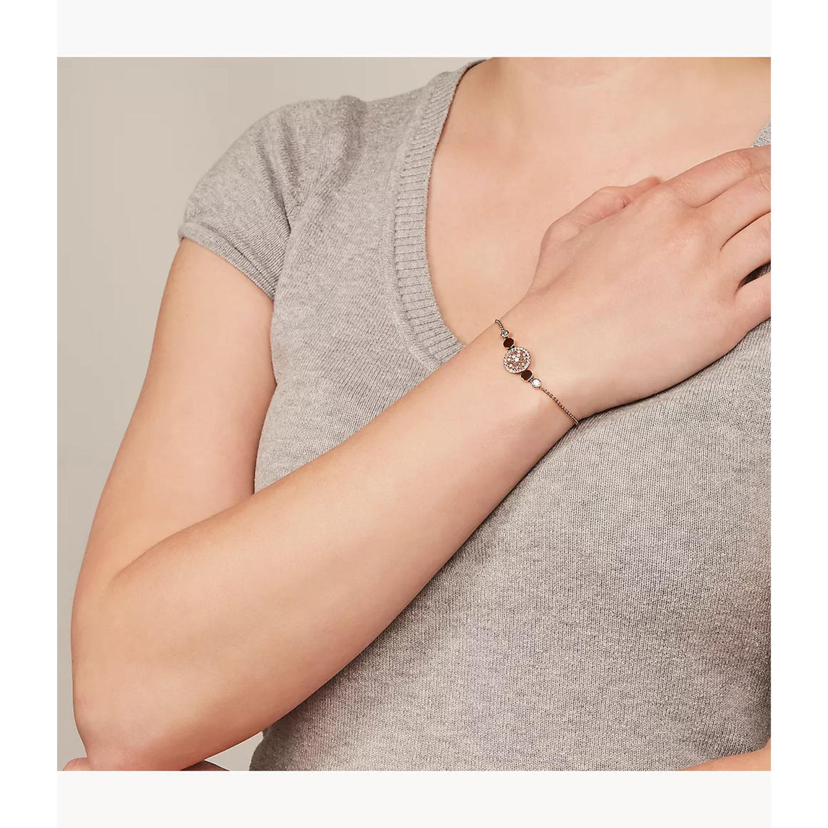Rose gold-tone mother-of-pearl disc bracelet on wrist