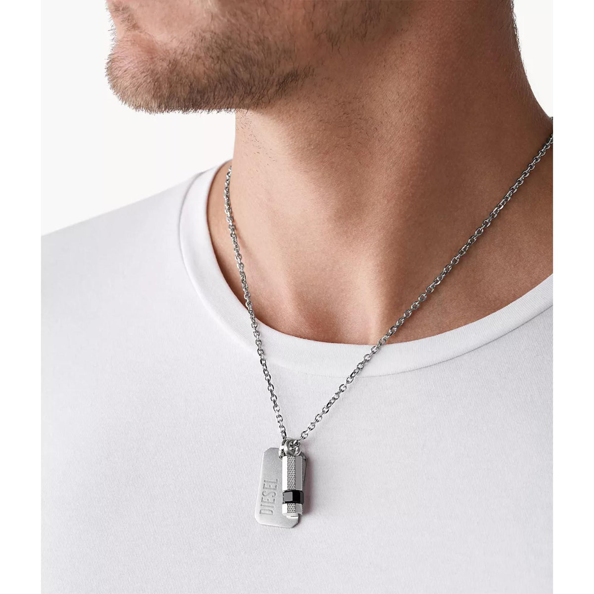Stainless steel double dog tag pendant necklace on wearer’s neck with Diesel engraved plate