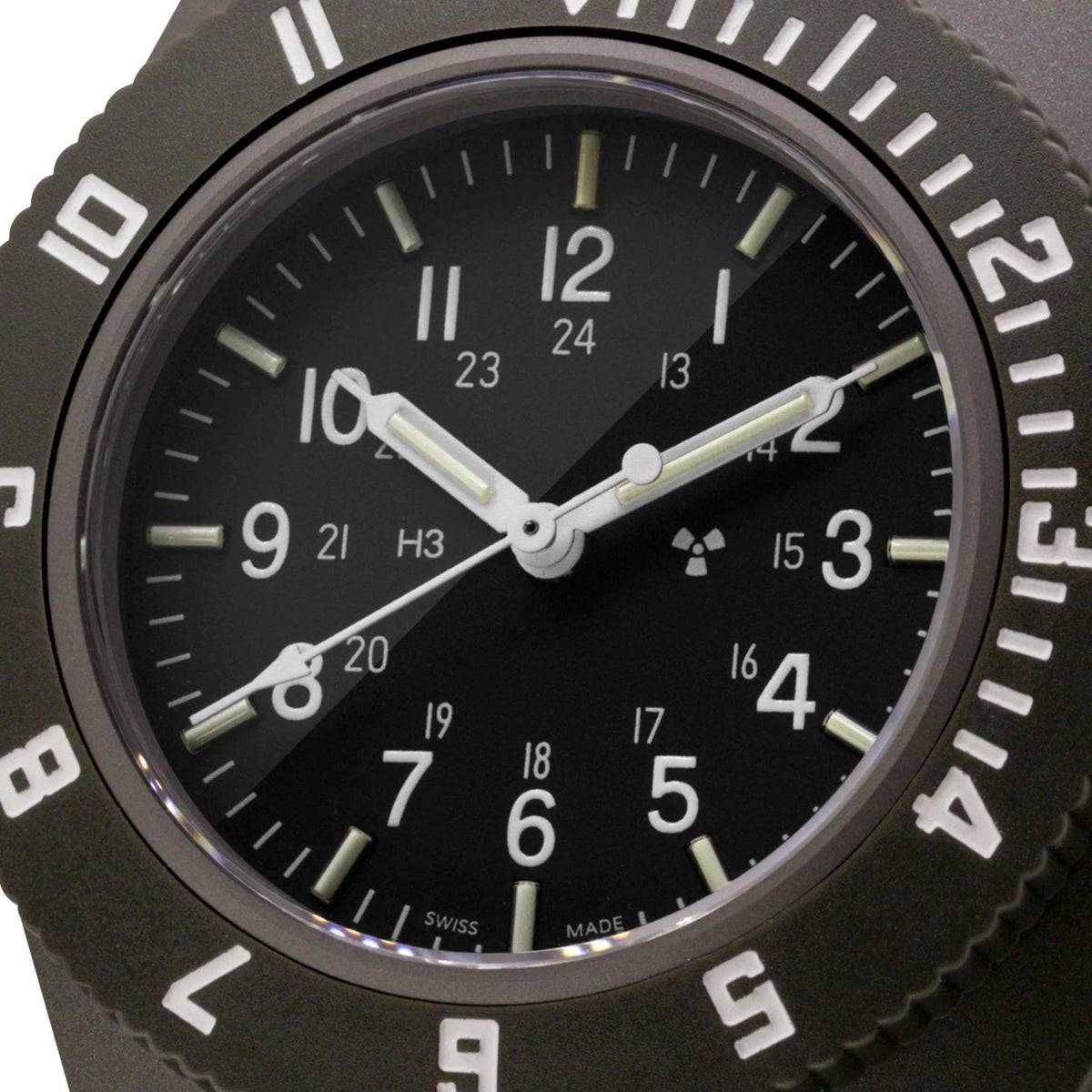 Black dial watch close-up with white hour markers and central hands under the glass.