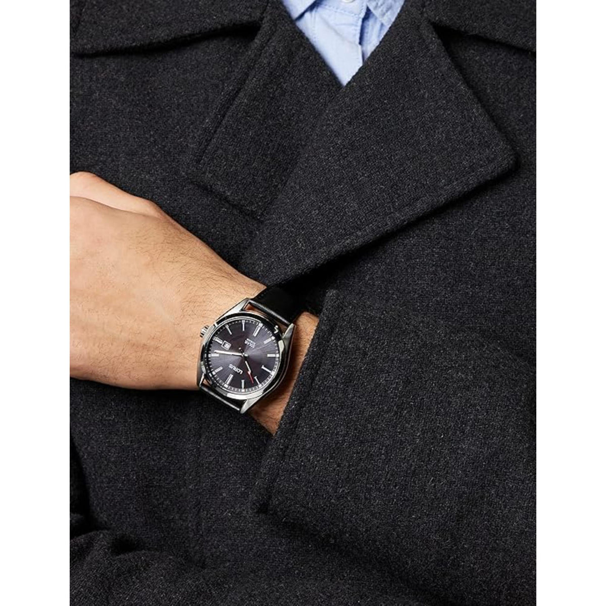 Men's solar watch on wrist with black dial and black strap