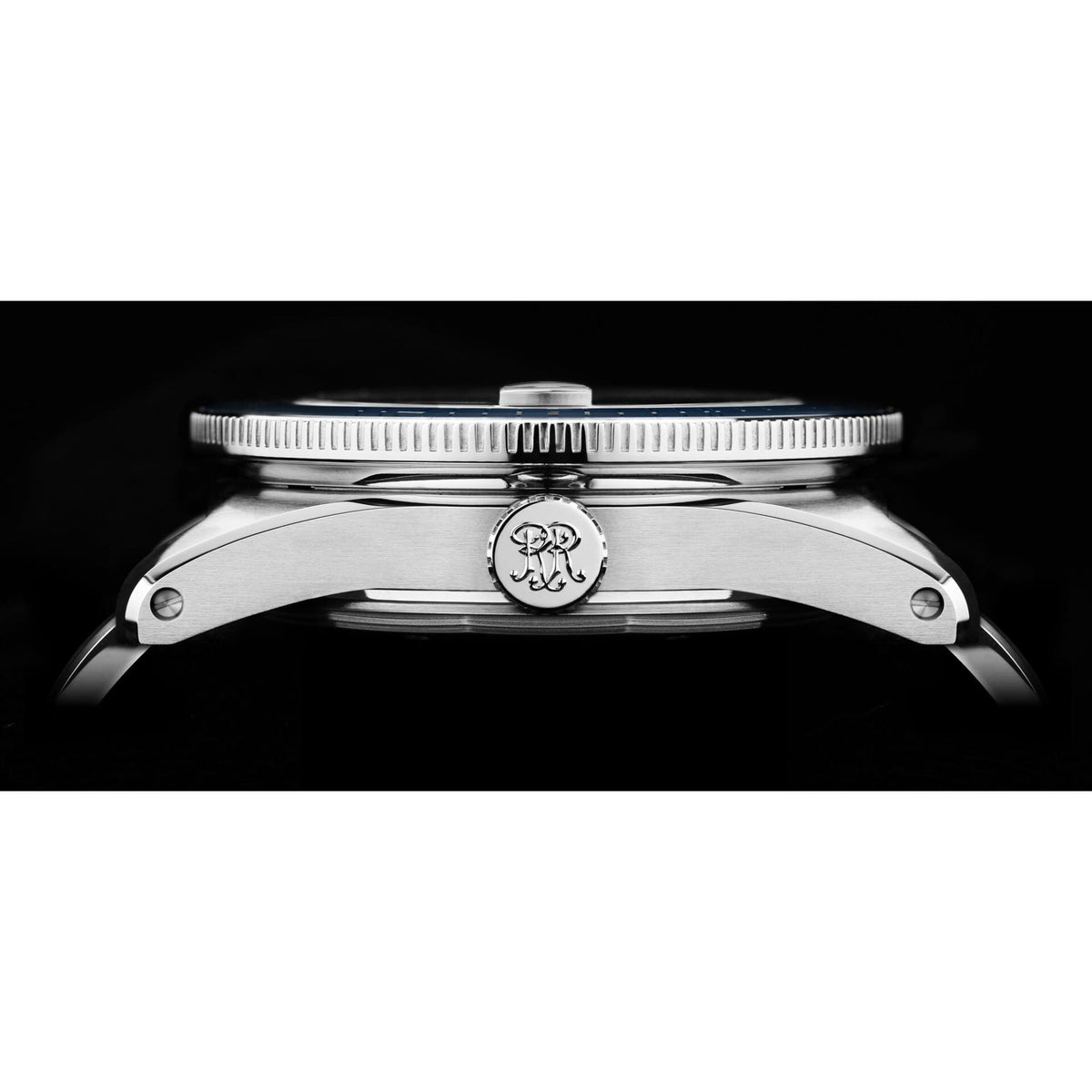 Stainless steel men’s diver watch case with ridged bezel and crown, side view