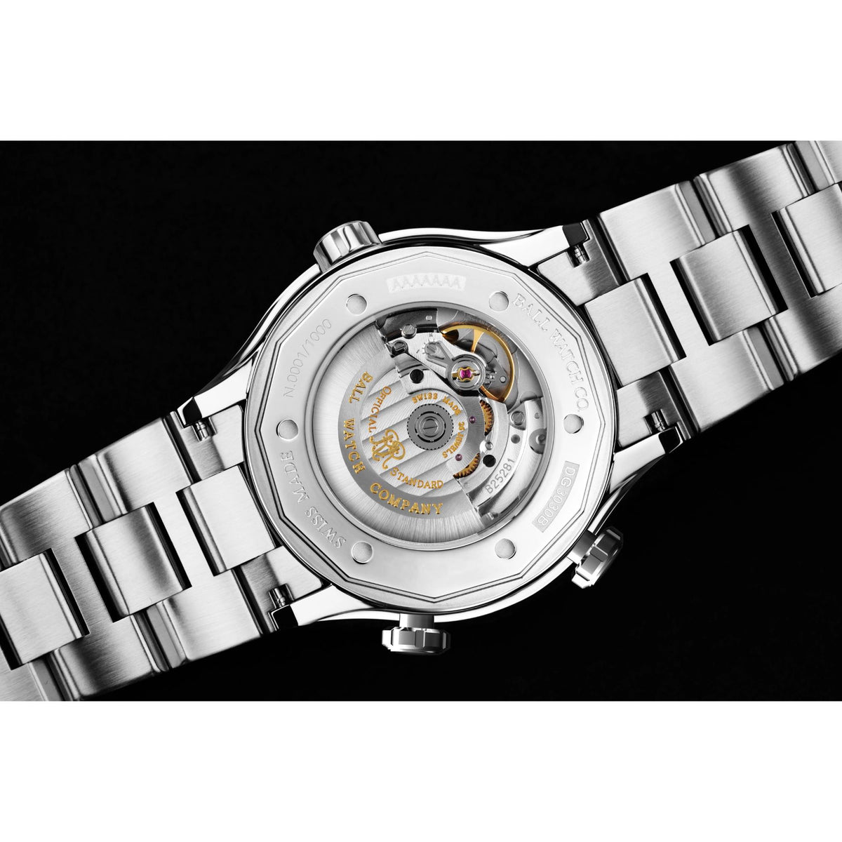 Stainless steel watch case back with bracelet, visible internal movement
