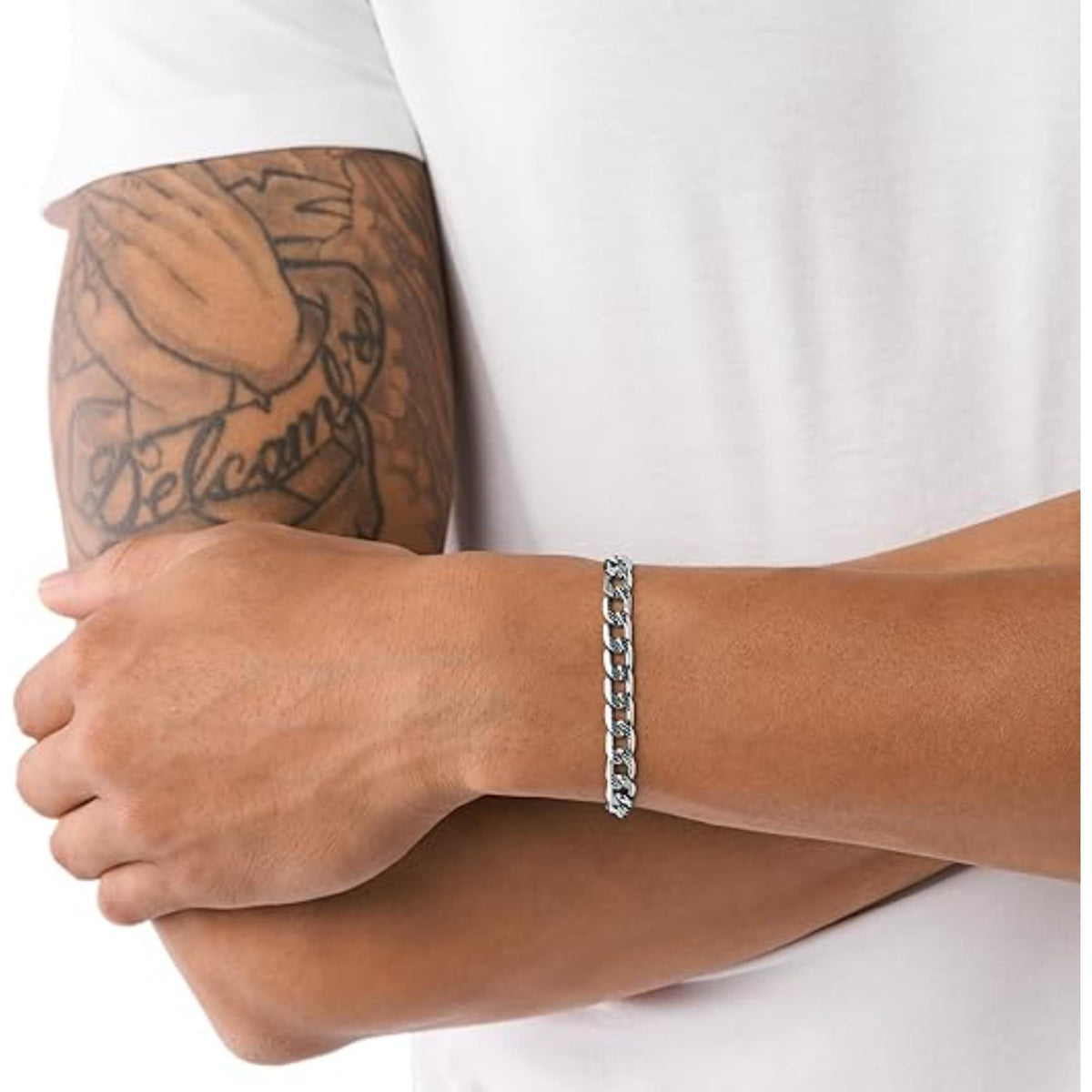 Silver chain bracelet worn on wrist with link pattern and metal clasp ring