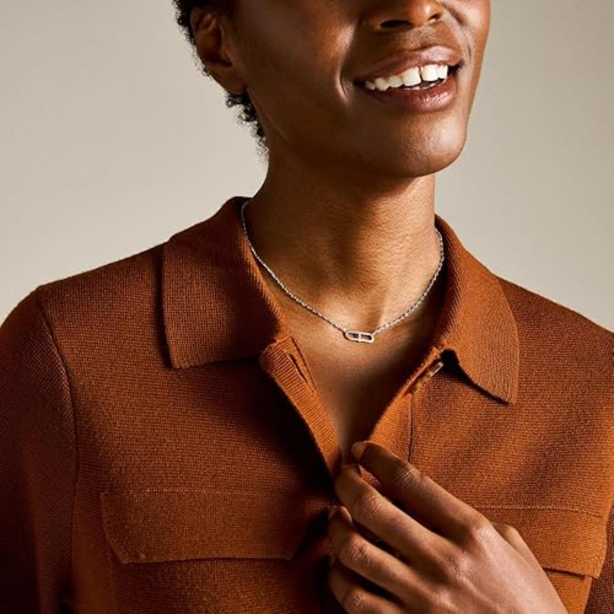 Sterling silver necklace on a woman's neckline, featuring an oval crystal pendant