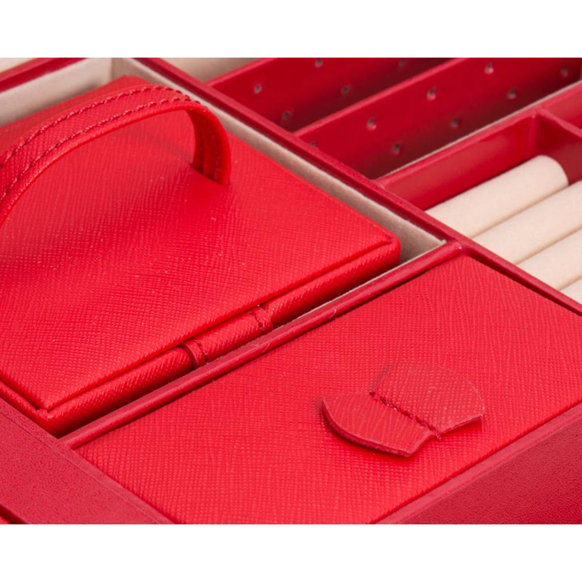 Red Saffiano leather jewelry box interior with compartments and ring slots, close-up
