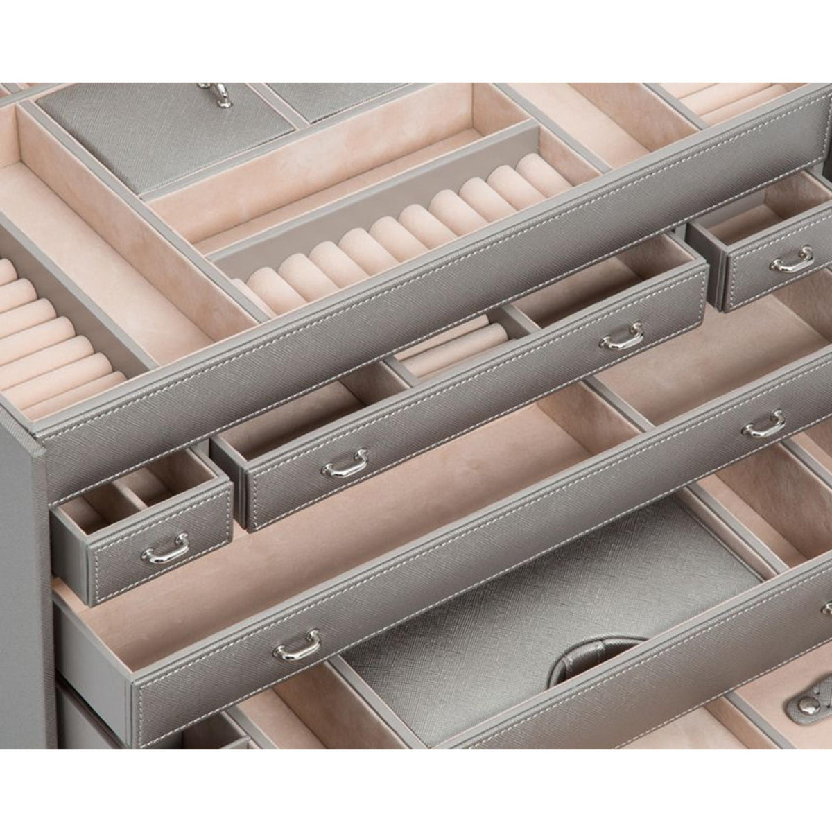 Jewelry armoire interior with padded compartments, stitched drawers, and silver pulls