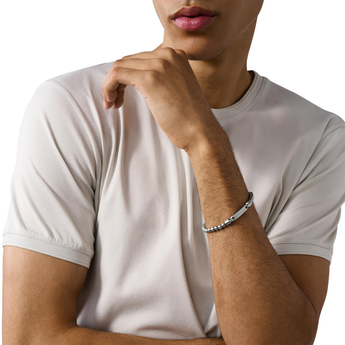 Stainless steel ID bracelet on model wrist with engraved center bar and chain links