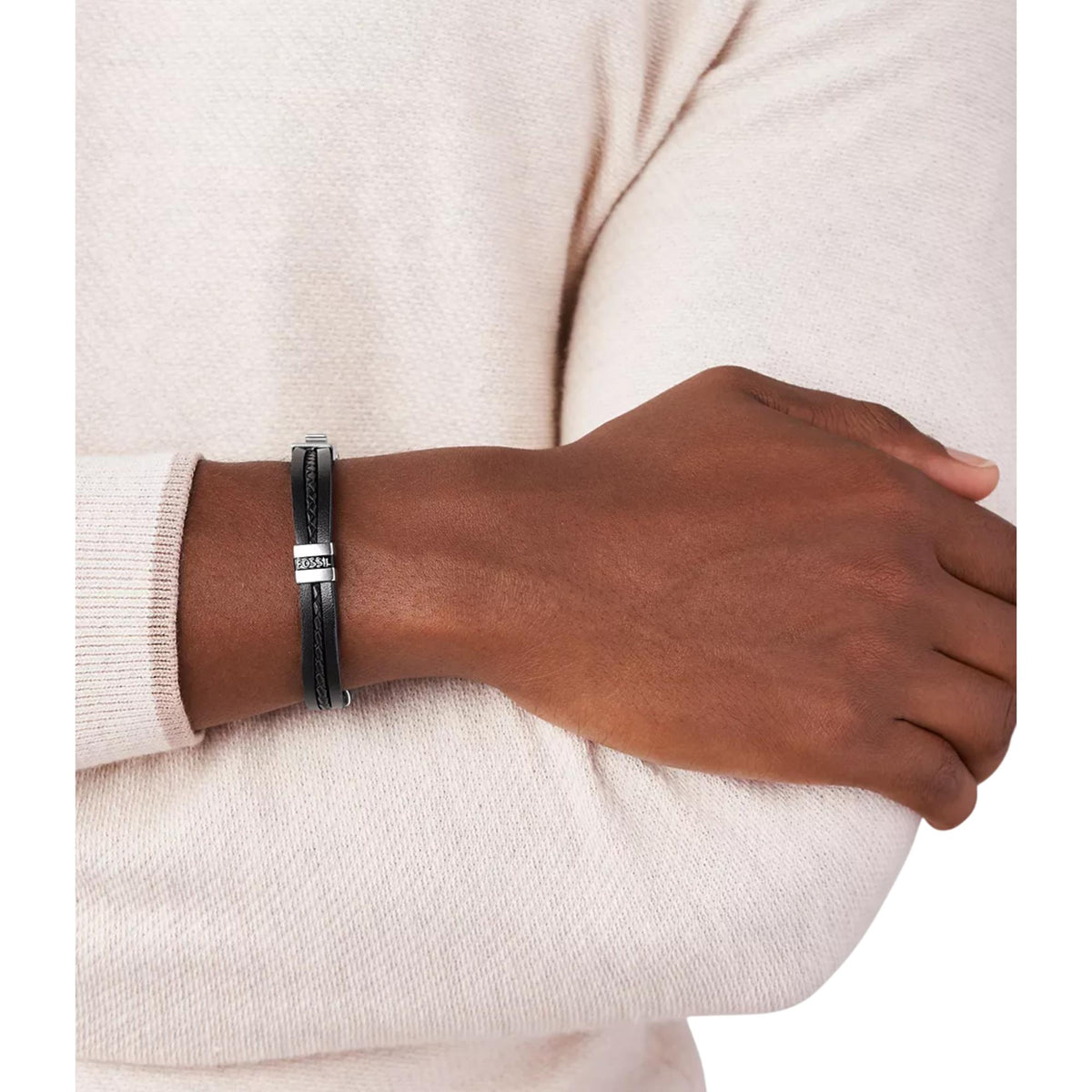 Black leather bracelet featuring silver-tone clasp and logo plate on an arm