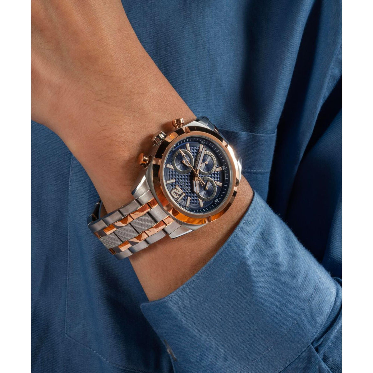 Men's stainless steel watch with blue dial, rose-gold bezel and two-tone metal bracelet.