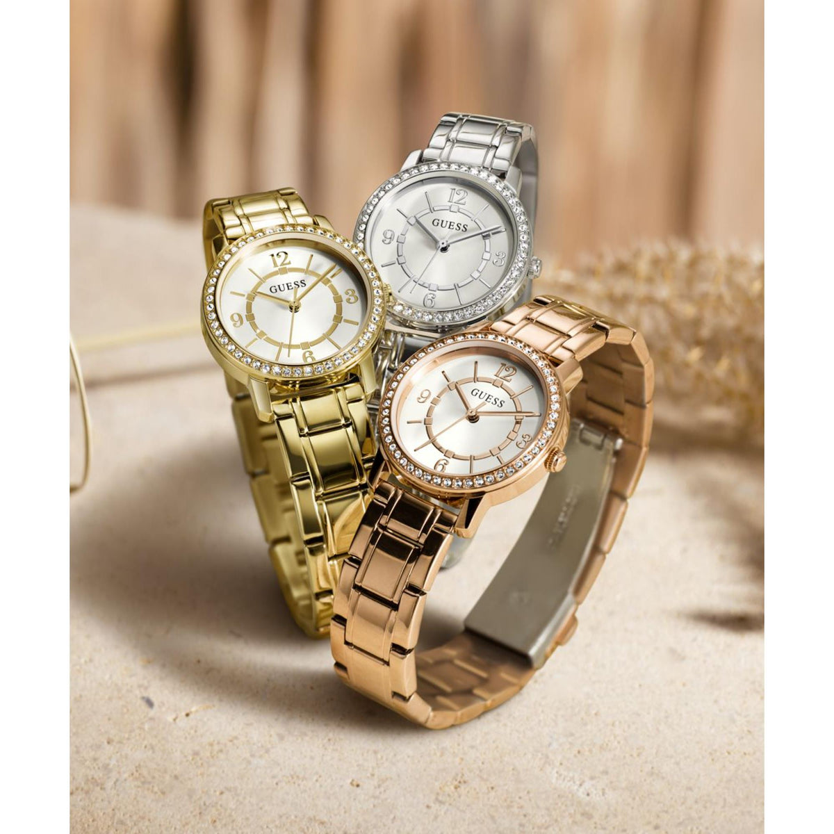 Set of three women’s watches with jeweled bezels and white, gold, and silver dials.