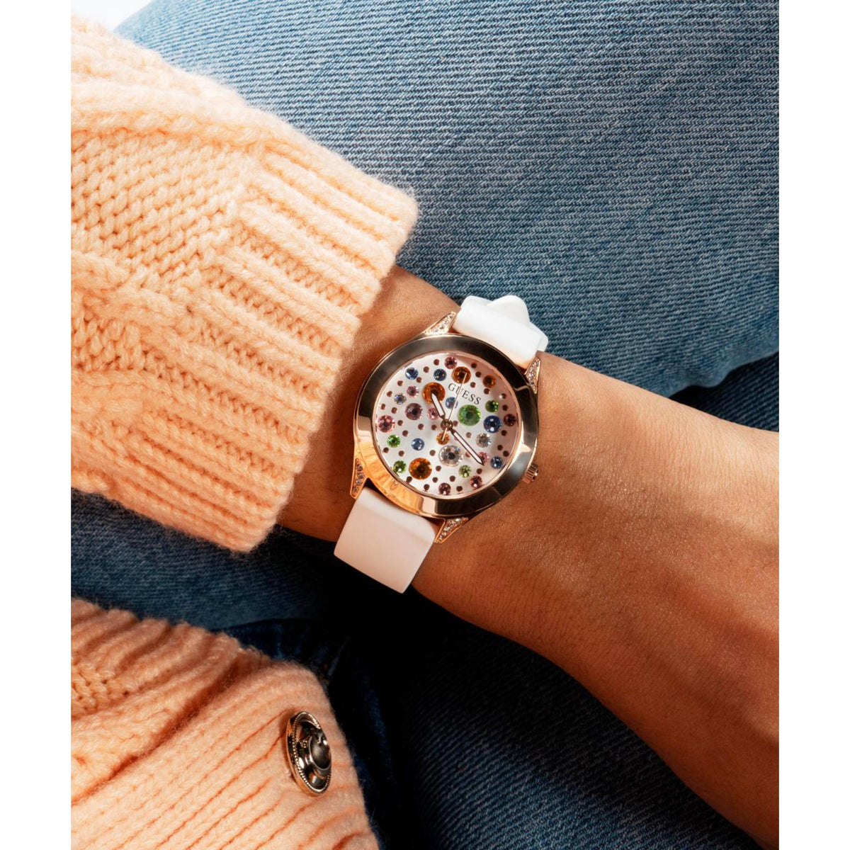 Women's white silicone strap watch on wrist, rose gold-tone case and multicolor dial