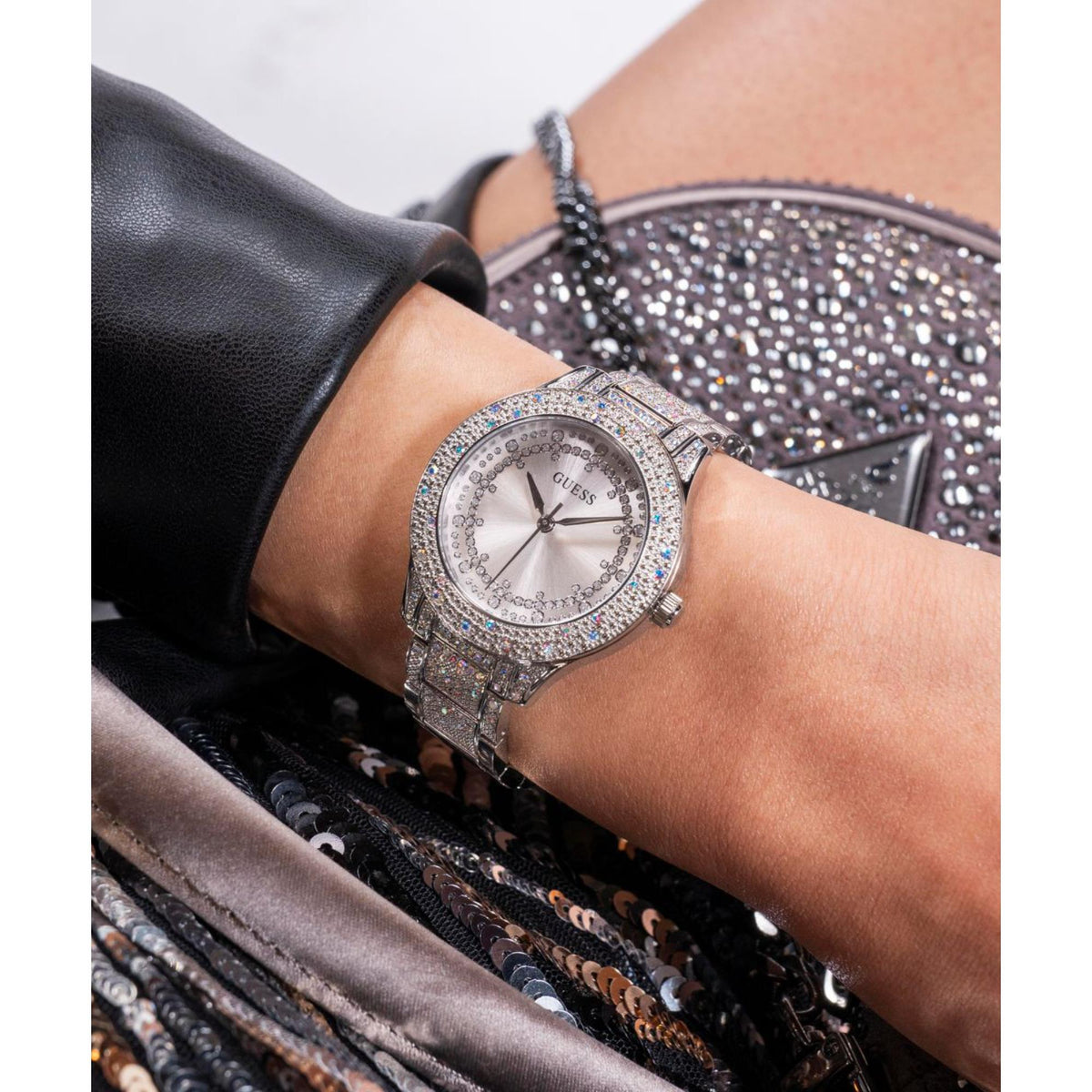 Women’s silver dial wristwatch with jeweled bezel and stainless steel link bracelet