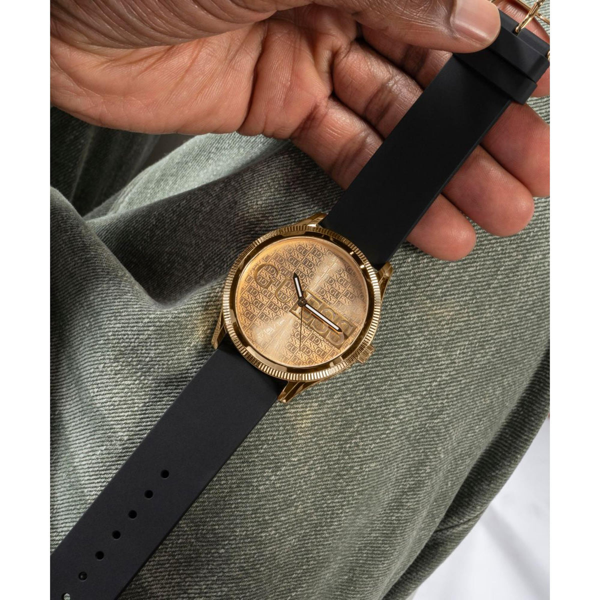 Men's black silicone strap watch with gold-tone round dial and baton markers
